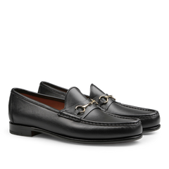 Black Funchal Leather Xim Horsebit Loafers by Carmina, crafted from black calf leather, feature a silver metal buckle detail, a low heel, and elegant stitching along the top edge.