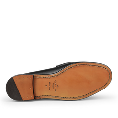 The image highlights the sole of the Black Funchal Leather Xim Horsebit Loafers from Carmina, featuring beige leather and stitching, along with a brand logo and size marking.