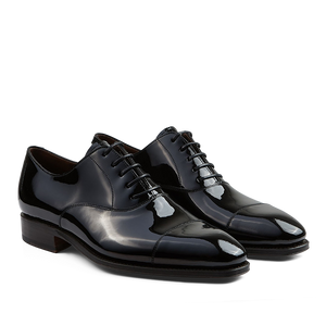 A pair of versatile, polished Carmina Black Rain Patent Leather Oxford shoes, Goodyear welted for durability.