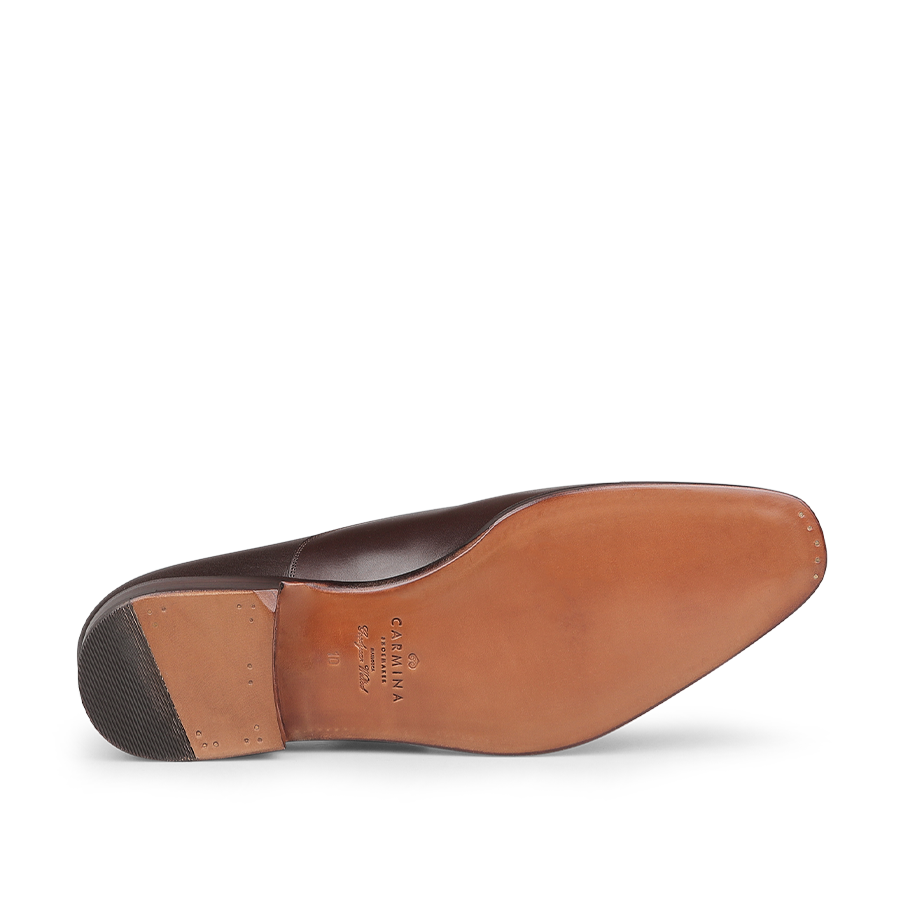 Bottom view of the Brown Calf Rain Captoe Rain Oxford Shoes from Carmina, featuring a tan leather sole and a rubber heel piece, highlighting the versatile design style reminiscent of Charles Goodyear's innovation.