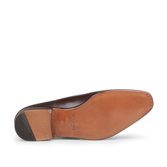 Bottom view of the Brown Calf Rain Captoe Rain Oxford Shoes from Carmina, featuring a tan leather sole and a rubber heel piece, highlighting the versatile design style reminiscent of Charles Goodyear's innovation.