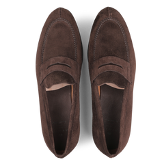 A pair of Carmina Brown Suede Forest Rubber Penny Loafers featuring a penny slot detail and a durable rubber sole, viewed from above.