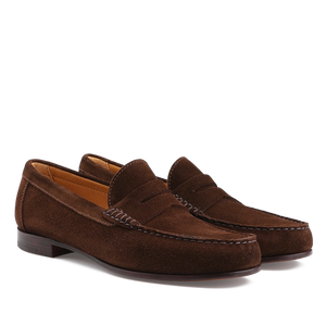 The Chocolate Repello Suede Xim Penny Loafers by Carmina feature a low heel, slip-on design, Blake rapid construction, and stitching details. They are shown on a white background.