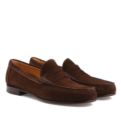 The Chocolate Repello Suede Xim Penny Loafers by Carmina feature a low heel, slip-on design, Blake rapid construction, and stitching details. They are shown on a white background.