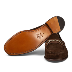 A pair of brown Carmina Chocolate Suede Leather Xim Horsebit Loafers on a transparent background.