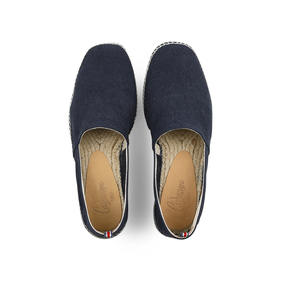 The Azul Oxford Cotton Pablo Espadrilles by Castañer feature an Oxford blue cotton upper, light brown insoles, and a tricolor ribbon on the heel—ideal for effortless summer style.