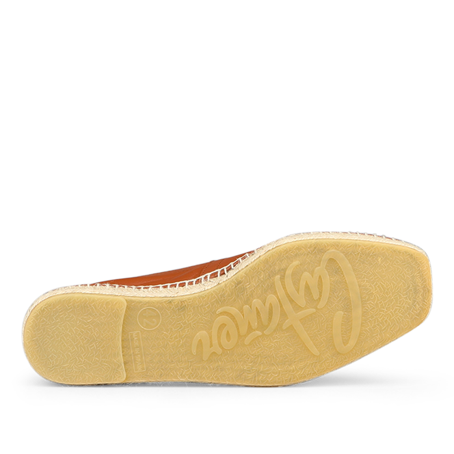 Close-up of a shoe sole with "Castañer" embossed. The Chestnut Brown Leather Pablo Espadrilles display a light textured pattern, highlighting their sophisticated design.