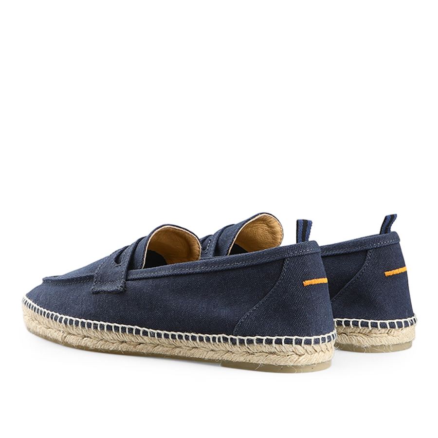 Castañer's Dark Blue Cotton Canvas Nacho Espadrilles showcase a navy upper, tan interior, and straw soles, viewed from the back.