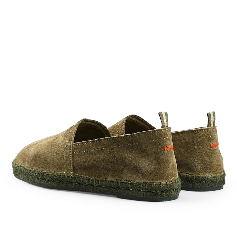 A pair of Castañer Dark Green Suede Leather Pablo Espadrilles with green woven jute soles and orange stitching on the back, shown from a rear angle.