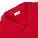 Close-up of an Altea coral red cotton towelling capri collar polo shirt label and collar.