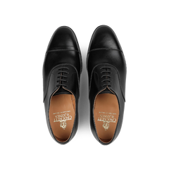 Crafted by Crockett & Jones, the Black Calf Leather Connaught Cap Oxfords showcase a polished silhouette and lace-up design. Made from premium black calf leather, their Goodyear-welted construction ensures durability and timeless elegance when viewed from above.