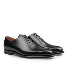 Featuring a pair of exquisitely crafted Alex Wholecuts by Crockett & Jones, these polished black calf leather lace-up dress shoes boast a refined silhouette with a low heel when viewed from the side.