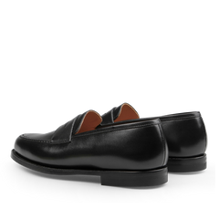 A pair of Crockett & Jones Black Fine Calf Leather Boston Loafers, featuring visible stitching and a low heel, are displayed from the back angle.