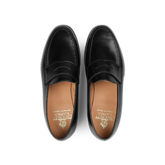 An overhead view of Boston Loafers from Crockett & Jones, expertly crafted from fine black calf leather and featuring brown insoles.