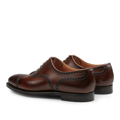 Introducing the Dark Brown Calf Leather Westfield Semi-Brogues by Crockett & Jones, these polished Oxford shoes showcase elegant semi-brogue detailing and durable black soles, making them an ideal choice for adding a touch of refinement to any ensemble.