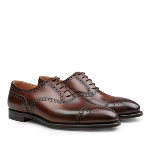 A pair of Dark Brown Calf Leather Westfield Semi-Brogues from Crockett & Jones, showcasing semi-brogue decorative perforations and black soles.