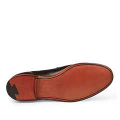 The image displays the sole of a pair of Crockett & Jones Dark Brown Cordovan Leather Harvard Loafers, showcasing a Goodyear-welted design with a stitched border and a textured black rubber heel.