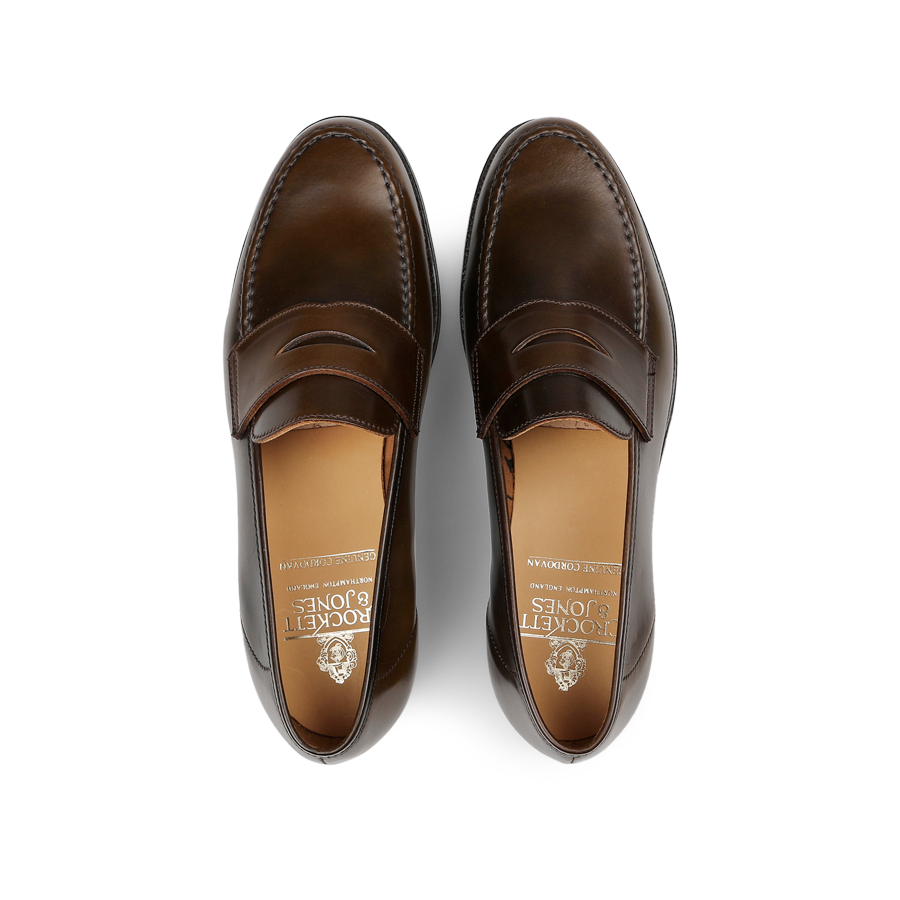 A pair of Crockett & Jones Dark Brown Cordovan Leather Harvard Loafers, impeccably crafted and viewed from above.