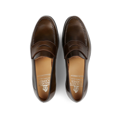 A pair of Crockett & Jones Dark Brown Cordovan Leather Harvard Loafers, impeccably crafted and viewed from above.