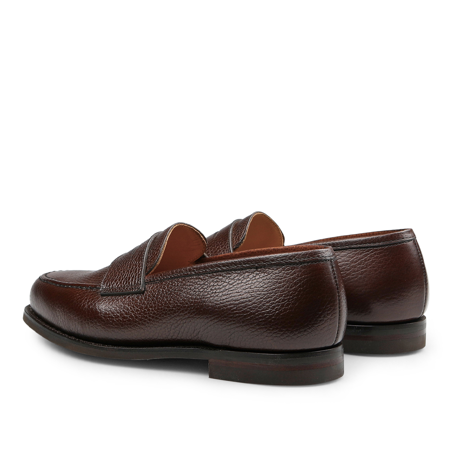 A pair of Crockett & Jones Dark Brown Country Calf Leather Boston Loafers, showcasing a textured finish and viewed from the back and slightly to the side.