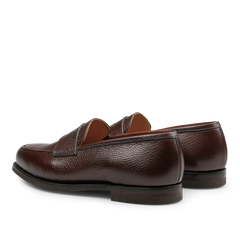 A pair of Crockett & Jones Dark Brown Country Calf Leather Boston Loafers, showcasing a textured finish and viewed from the back and slightly to the side.