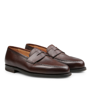 Crockett & Jones presents the Dark Brown Country Calf Leather Boston Loafers, featuring a textured finish and city rubber sole, displayed side by side on a white background. These loafers epitomize the enduring elegance of the classic Boston penny loafer style.