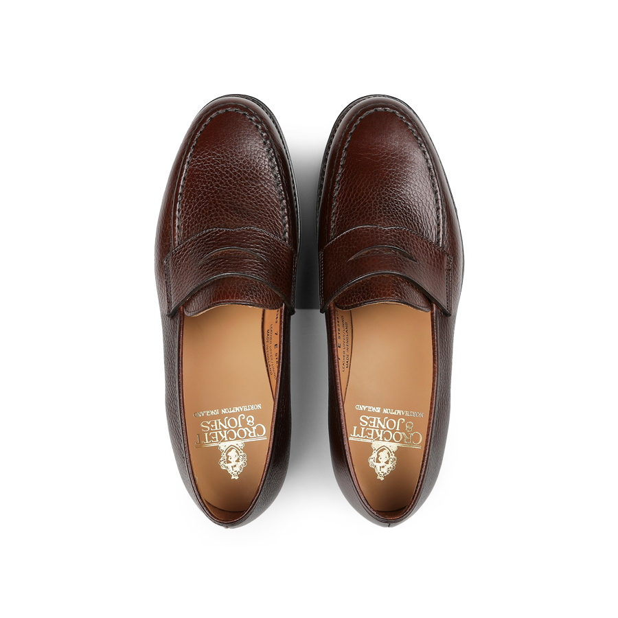 Dark brown Country Calf Leather Boston loafers by Crockett & Jones, showcasing Goodyear-welted stitching detail, captured from an overhead view with visible branding inside the shoes.