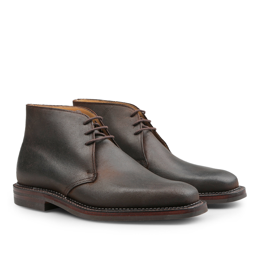 The Dark Brown Rough-Out Suede Molton Boots from Crockett & Jones, featuring laces and round toes with expertly crafted Goodyear welt construction, are showcased on a white background.