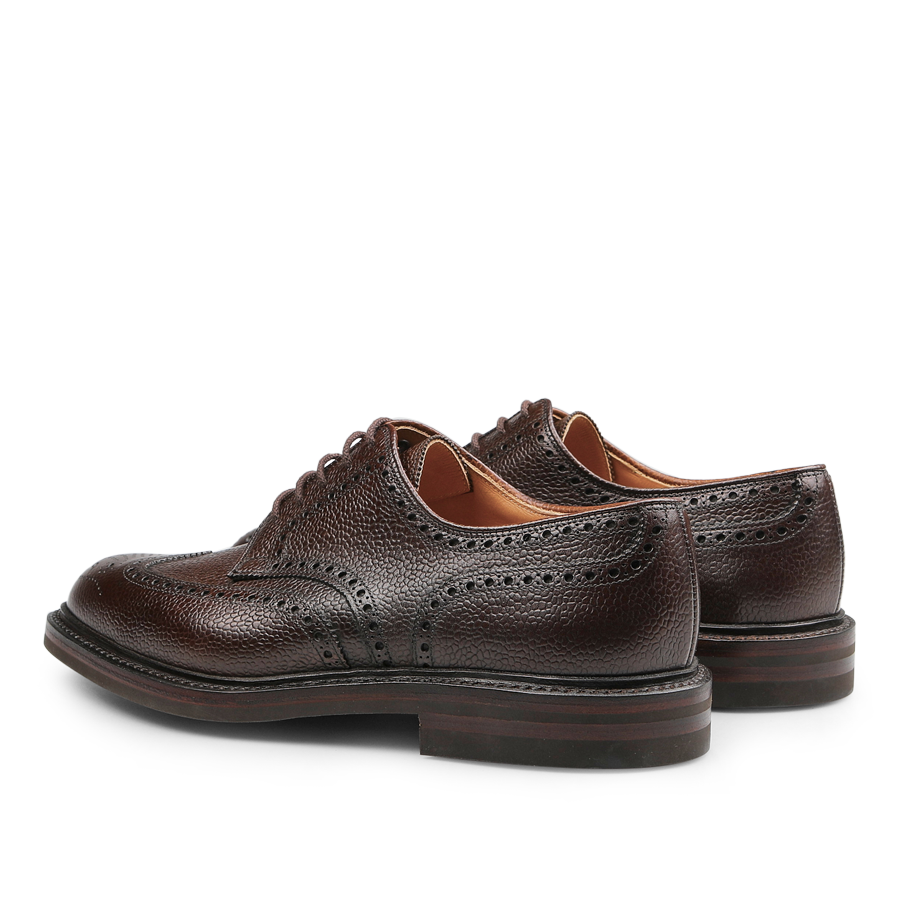 The Dark Brown Scotch Grain Leather Pembroke Brogues by Crockett & Jones, crafted with decorative perforations and laces, are displayed from a rear-side view on a plain white background.