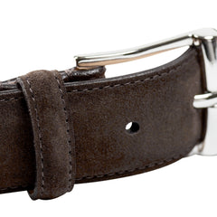 A close-up of the Crockett & Jones Dark Brown Suede Leather 32mm Belt showcases its silver-toned buckle and loop, with a full leather lining for enhanced durability.