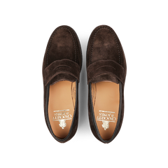 A pair of Dark Brown Suede Leather Boston Loafers from Crockett & Jones, viewed from above, highlight decorative stitching and the brand's logo on the leather insole. Expertly crafted and Goodyear-welted for durability, these loafers encapsulate timeless elegance.