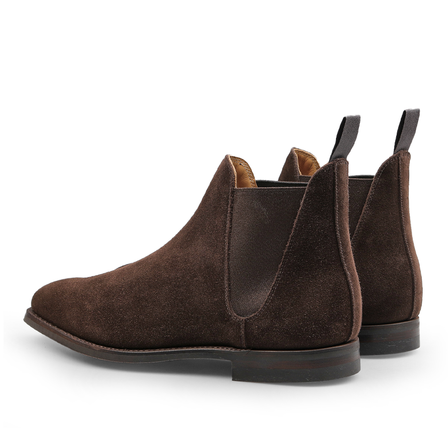 The Crockett & Jones Dark Brown Suede Leather Chelsea VIII Boots are elegantly designed with elastic side panels and pull tabs, featuring a classic style enhanced by Goodyear welted construction, as seen from the back.