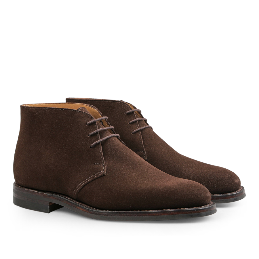 A pair of Dark Brown Suede Leather Chiltern Boots by Crockett & Jones with thin laces, highlighting their classic Goodyear-welted design from the side against a white background.