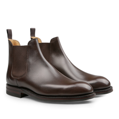 Crockett & Jones presents the Dark Brown Wax Calf Leather Chelsea V Boots, designed with elastic side panels and pull tabs, and crafted with a durable Goodyear welted sole.