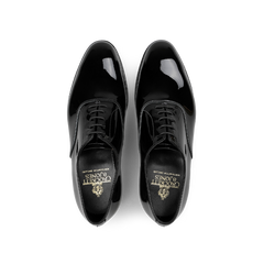 The Black Patent Calf Leather Overton Oxfords by Crockett & Jones are crafted from shiny black patent calf leather and feature a classic design with laces, viewed from above.