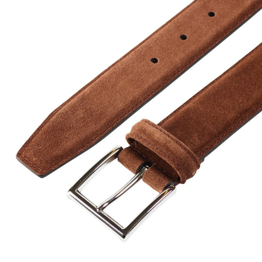 The Polo Brown Suede Leather 32mm Belt by Crockett & Jones, featuring a silver buckle, is displayed from above.