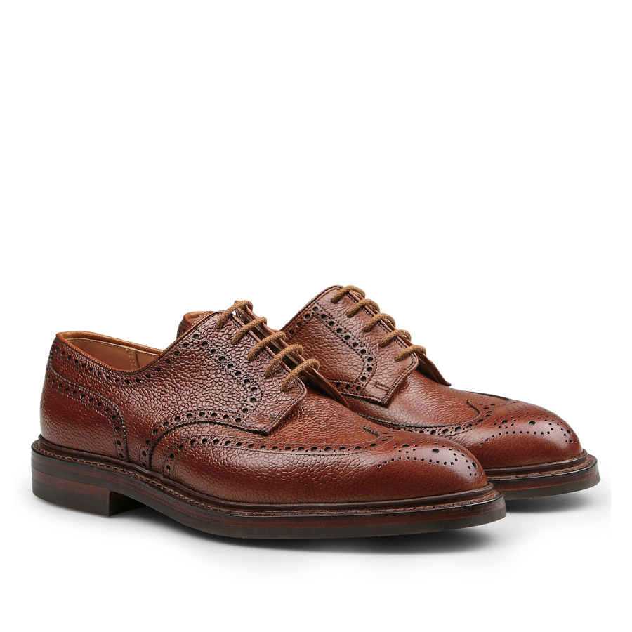 A pair of Crockett & Jones Tan Scotch Grain Leather Pembroke Brogues featuring detailed stitching and crafted with Goodyear-welted construction for lasting durability, offering a classic lace-up closure in premium brown leather.