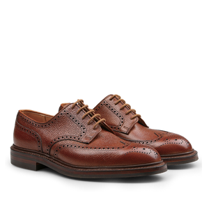 A pair of Crockett & Jones Tan Scotch Grain Leather Pembroke Brogues featuring detailed stitching and crafted with Goodyear-welted construction for lasting durability, offering a classic lace-up closure in premium brown leather.