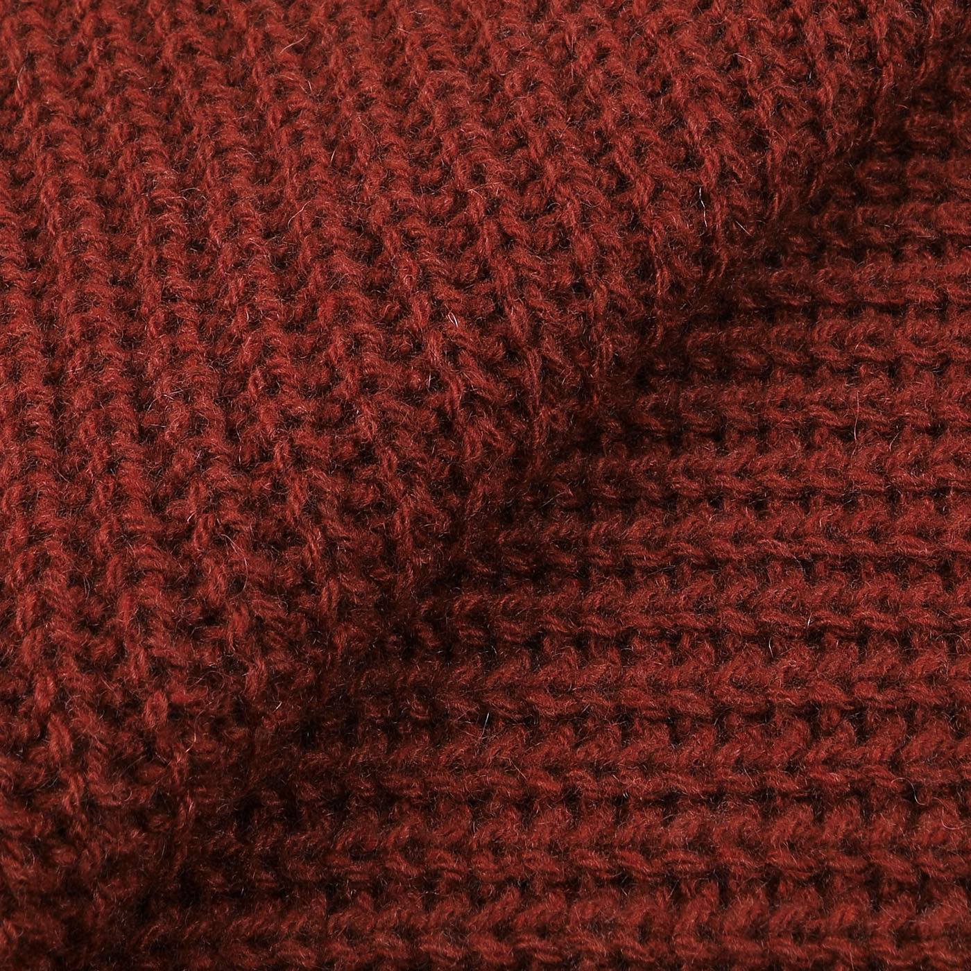 Close-up of the Burnt Red Cable Knit Cashmere Scarf by Daniele Fiesoli, showcasing its intricate pattern and soft, textured material.