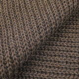 Close-up of the Corteccia Brown Cable Knit Cashmere Scarf by Daniele Fiesoli, highlighting its upcycled cashmere fabric with a coarse texture and large, distinct stitches.