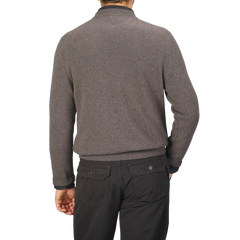 A person wearing a Corteccia Brown Cashmere Crewneck Sweater by Daniele Fiesoli and black pants is shown from the back against a plain background.