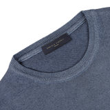 Close-up of a Dark Blue Melange Merino Wool Crewneck, crafted from extra fine merino wool, with a visible neck tag displaying "Daniele Fiesoli" and "Italy.