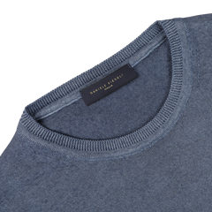 Close-up of a Dark Blue Melange Merino Wool Crewneck, crafted from extra fine merino wool, with a visible neck tag displaying "Daniele Fiesoli" and "Italy.