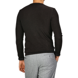 A person is seen from the back wearing a Daniele Fiesoli Dark Brown Merino Wool Crewneck and gray pants.