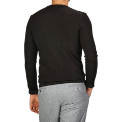 A person is seen from the back wearing a Daniele Fiesoli Dark Brown Merino Wool Crewneck and gray pants.