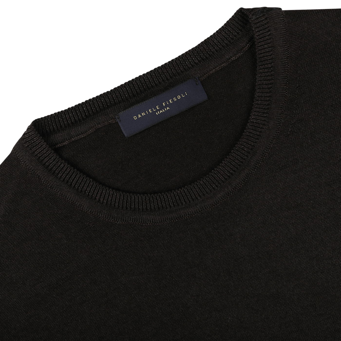 Close-up of a dark brown crew neck sweater, crafted from luxurious merino wool, with a dark label sewn inside the collar displaying "Daniele Fiesoli" in gold lettering.