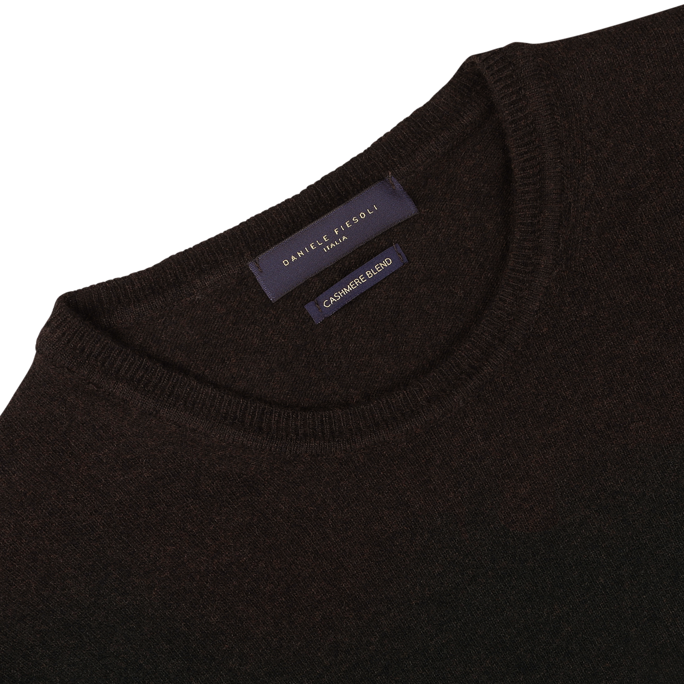 A close-up of the Dark Brown Wool Cashmere Crewneck sweater reveals a label reading "Daniele Fiesoli," highlighting its luxurious blend of wool and cashmere, Made in Italy.