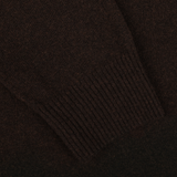 Close-up of a dark brown knitted sleeve with ribbed cuff, part of the luxurious Daniele Fiesoli Dark Brown Wool Cashmere Crewneck sweater, made in Italy from a soft wool-cashmere blend.