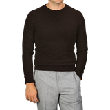 A person wearing a Daniele Fiesoli Dark Brown Wool Cashmere Crewneck and light gray pants. The person's face is not visible.