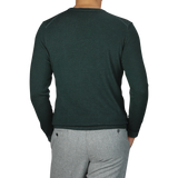 A person is shown from the back, wearing a Dark Green Wool Cashmere Crewneck by Daniele Fiesoli and light gray pants. The luxurious sweater, showcasing exquisite craftsmanship, is absolutely made in Italy.